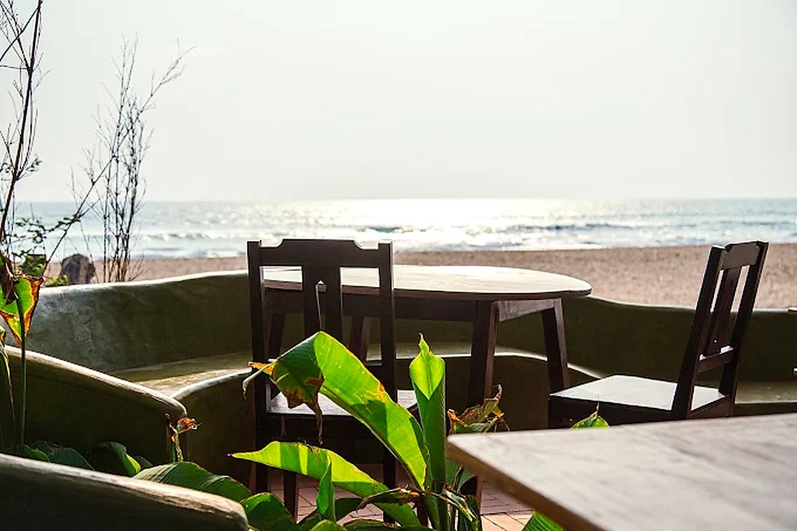 A table set facing the open sea at sunset
